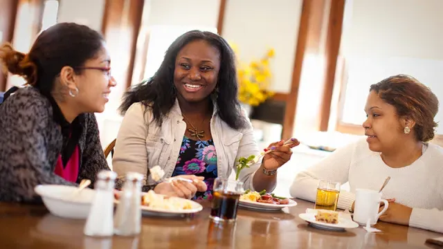 Three students in a dining room